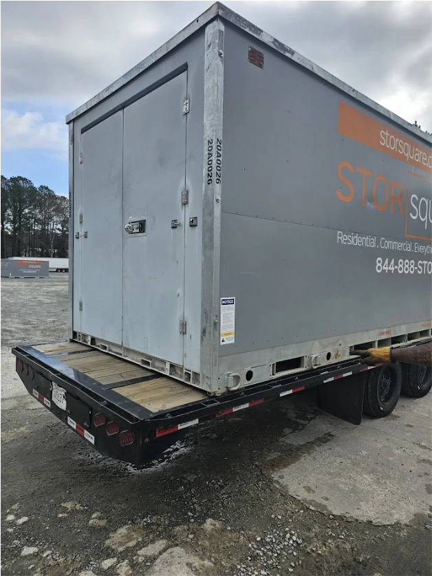 STORsquare moving container loaded onto a flatbed truck in Duluth, GA at an outdoor lot with other units visible