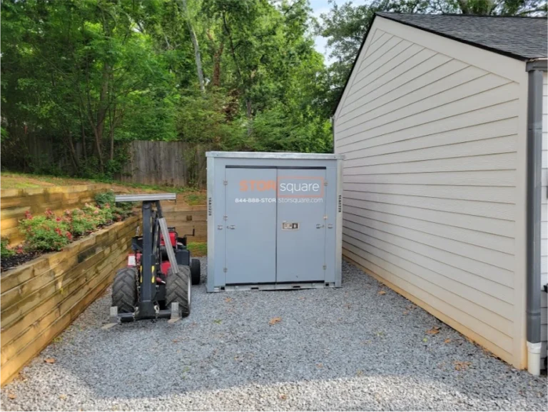 STORsquare portable moving and storage container positioned in a narrow side yard in Orlando with the MULE system beside it