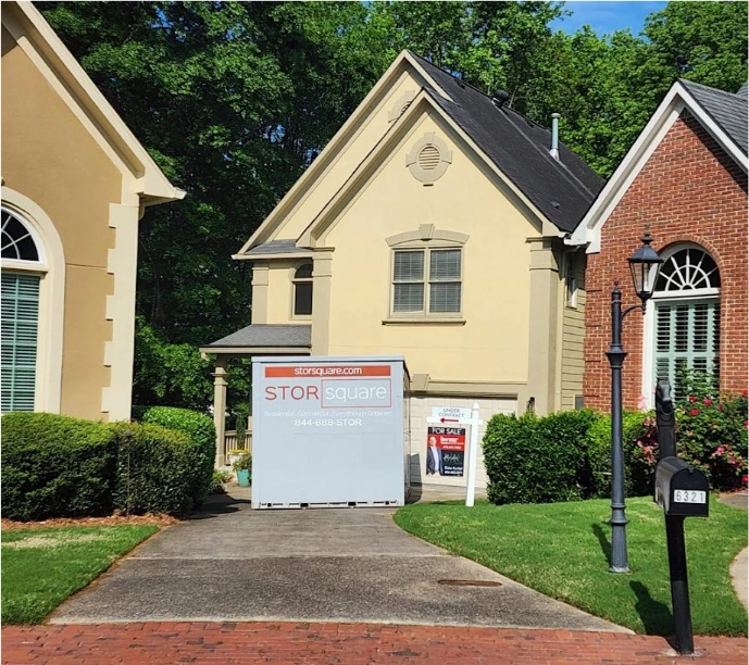 STORsquare portable storage unit placed on a residential driveway in Cumming, GA for home staging near a house