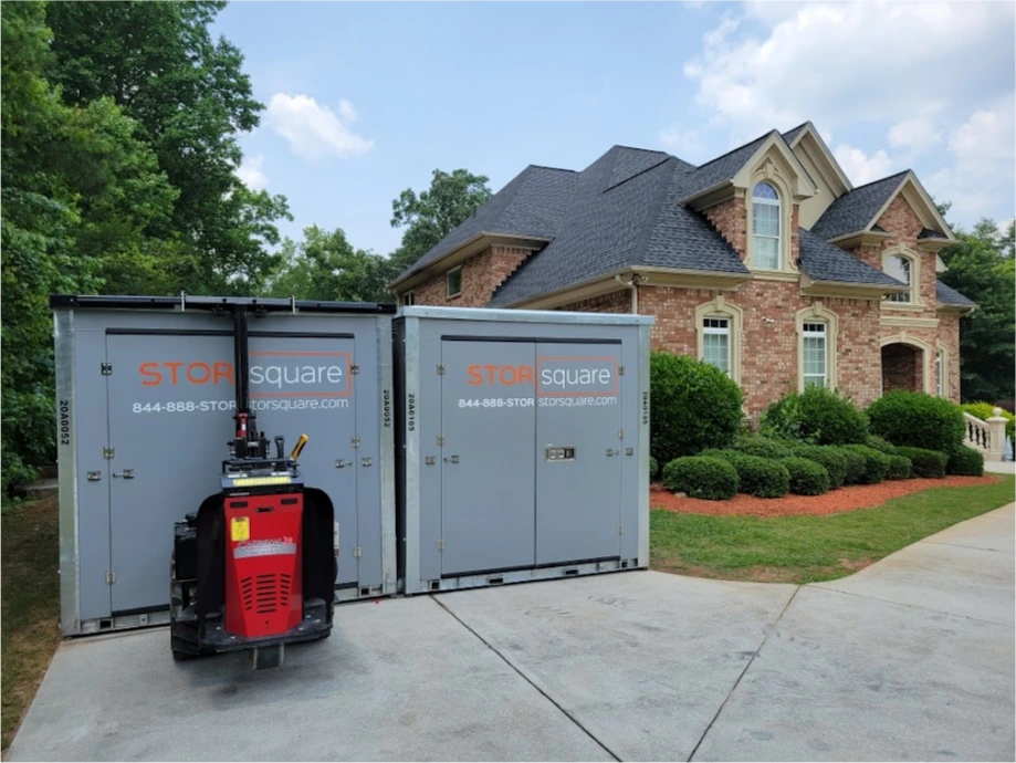 STORsquare portable storage units placed on a residential driveway in Cumming, GA with multiple containers near a home