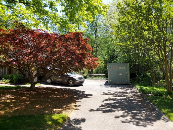 STORsquare portable storage container placed in a shaded Hickory NC driveway surrounded by trees and residential landscaping.