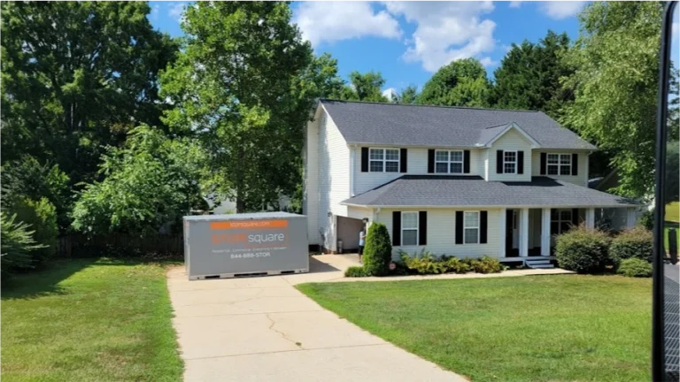 STORsquare portable storage units placed in a Pinehurst residential driveway beside a two-story home