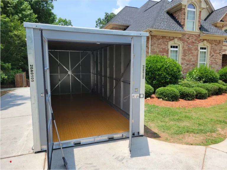 Open STORsquare portable storage units in a Lincolnton driveway showing interior space beside a residential home