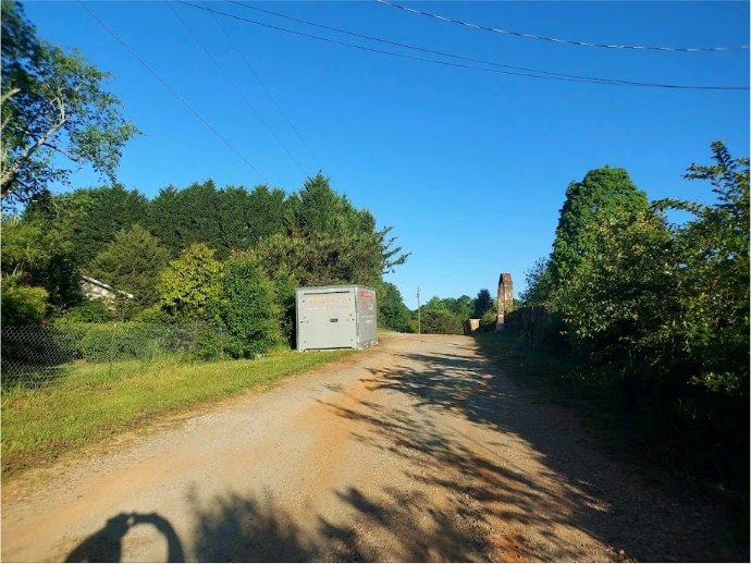 STORsquare portable storage units placed along a Belmont NC rural road with trees and fencing nearby