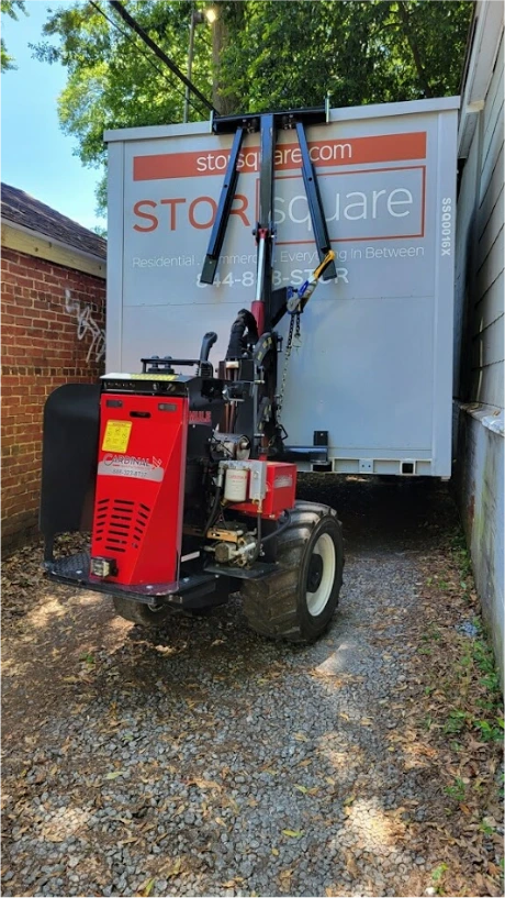 STORsquare portable storage unit being positioned in a tight residential space in Cumming, GA using specialized equipment
