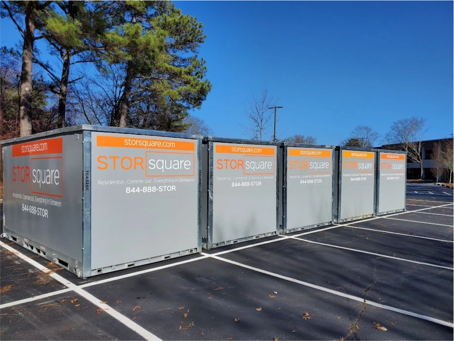 Multiple STORsquare storage container rentals lined up in a Lincolnton parking lot with clear access lanes