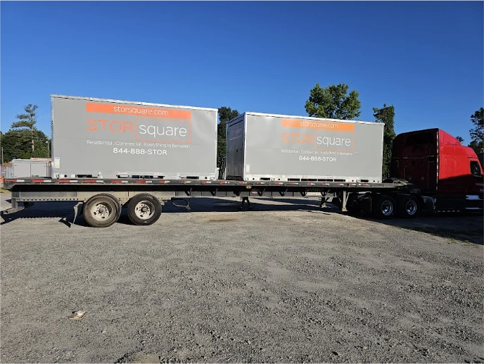 Two STORsquare storage container rentals loaded on a transport truck in Fort Mill for multi-container delivery