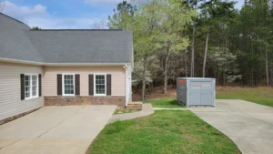 Portable storage container in driveway during a move showing what to pack first for easy access on moving day
