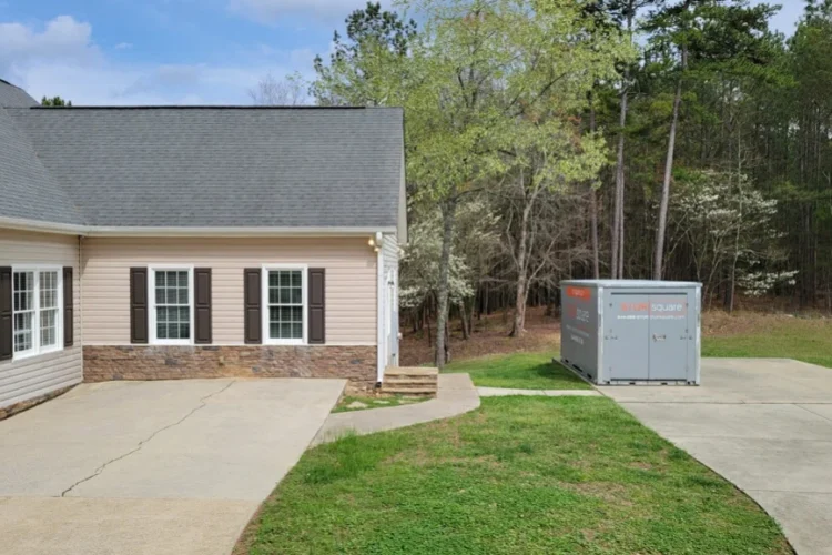 Portable storage container in driveway during a move showing what to pack first for easy access on moving day