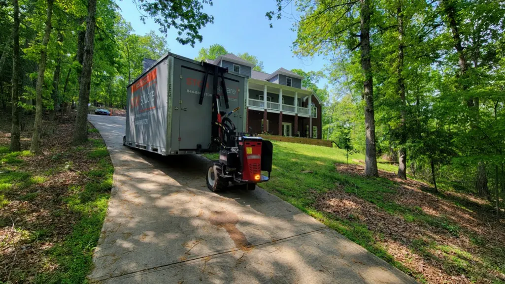 On-site storage containers for roofing delivered to a residential driveway for secure material and equipment storage