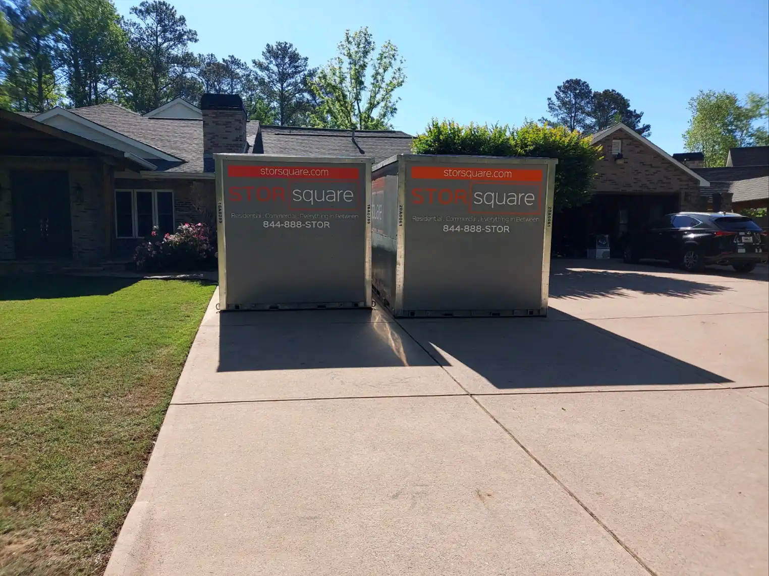 Two portable storage containers in a driveway helping homeowners prioritize home improvements before selling