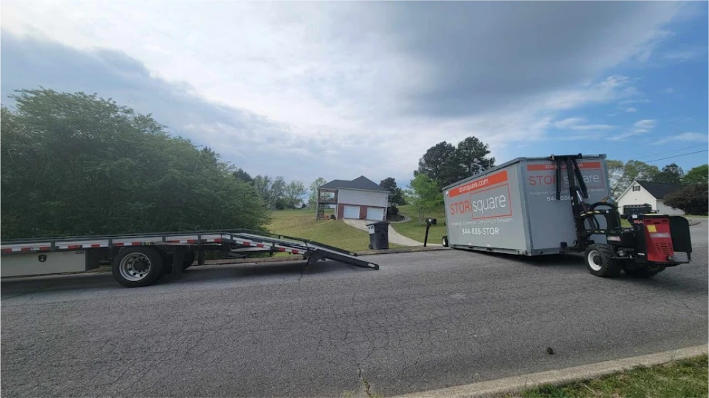 STORsquare uses the Mule delivery system to place a storage container from a flatbed in Brookshire.