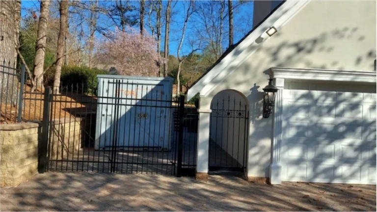 STORsquare storage container placed behind a gated Brookshire driveway beside a residential garage.