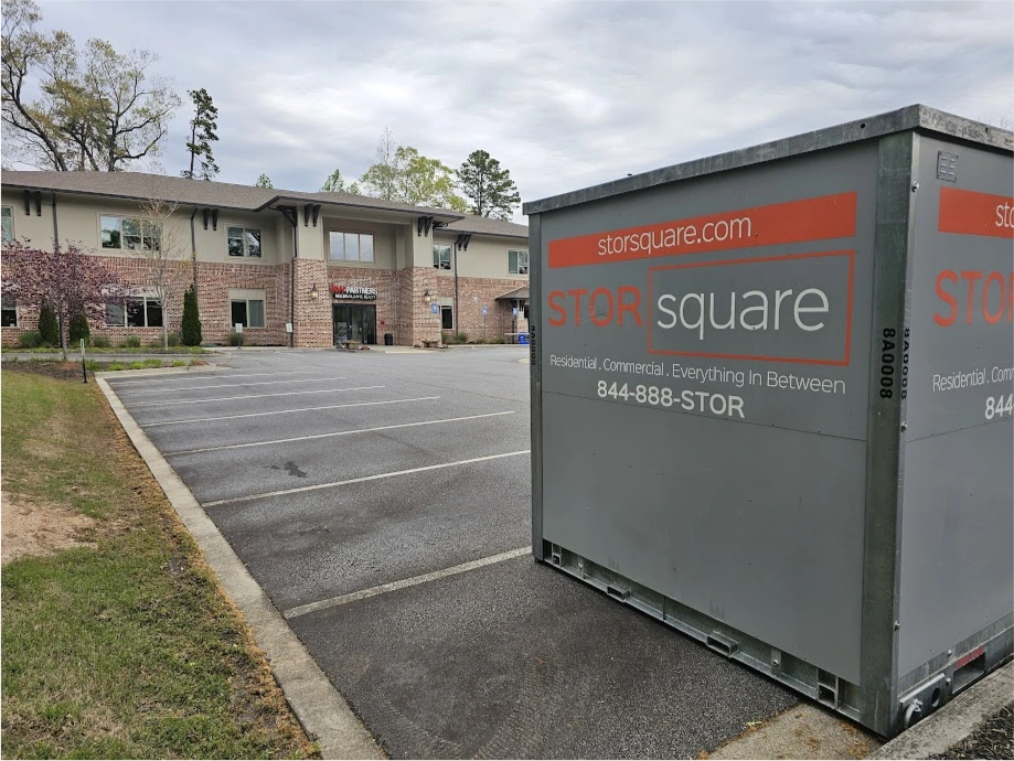 STORsquare portable storage containers placed in a commercial parking lot for business storage, moving, or renovation support in Harrisburg, NC.