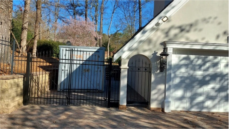STORsquare portable storage container placed inside a gated residential driveway for secure home storage in Loudon, TN.