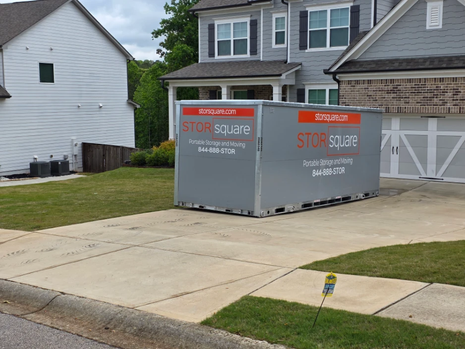 STORsquare portable storage unit in a residential driveway for decluttering, moving, or remodeling projects