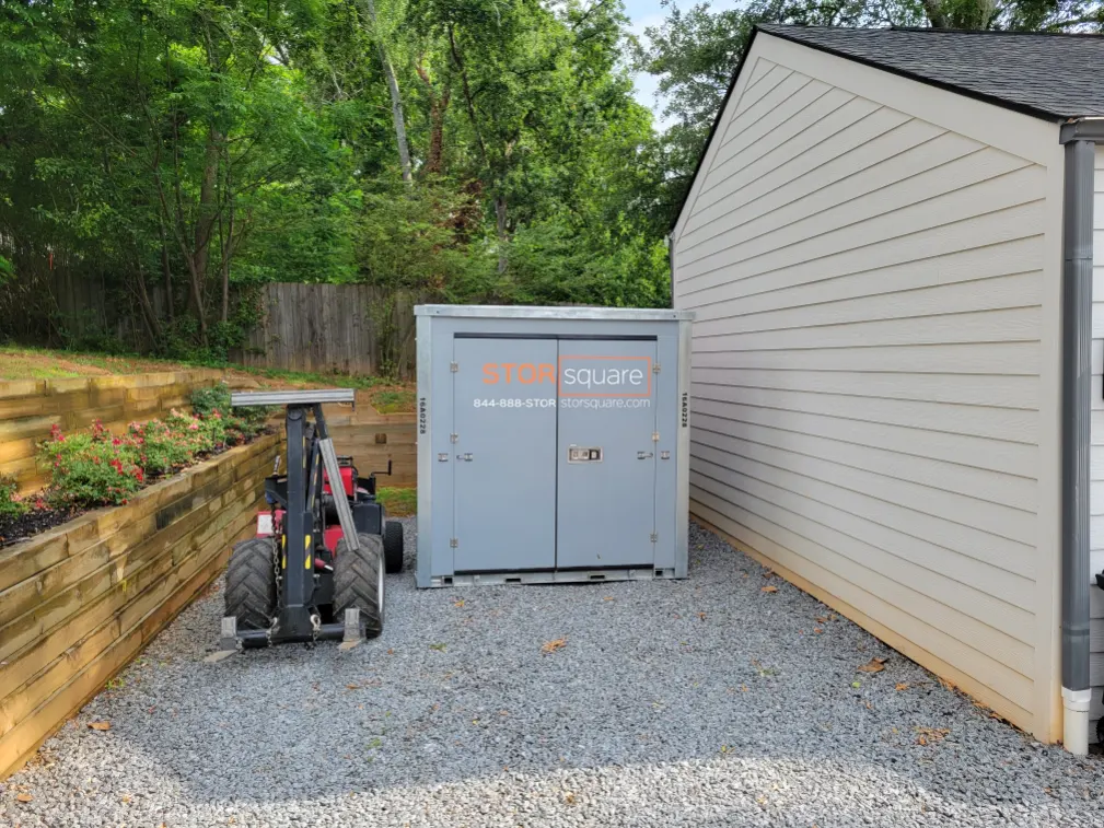 Portable storage unit placed beside a home for flexible moving and storage