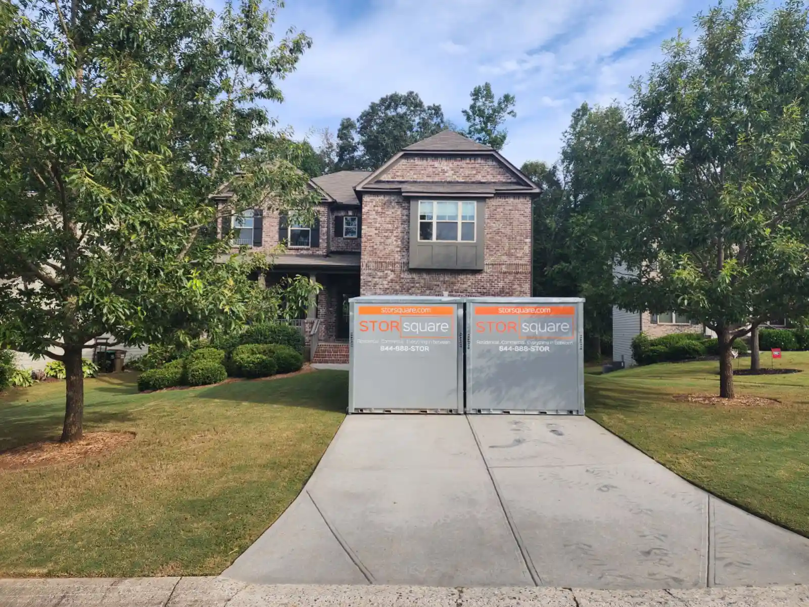 Portable storage containers placed in a residential driveway for a home move and temporary storage needs