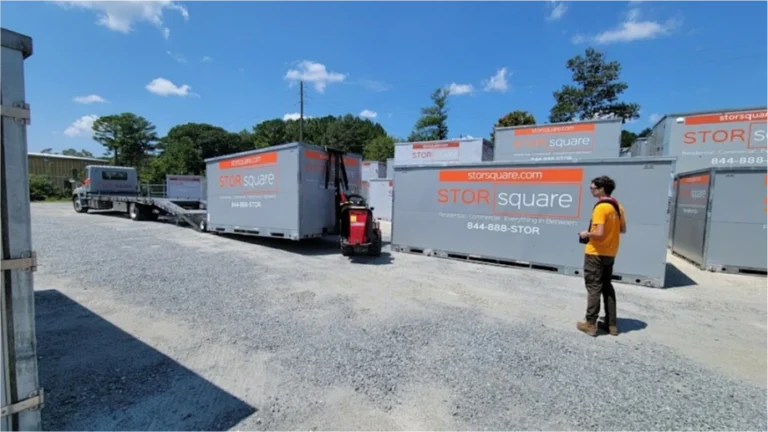 STORsquare containers and Mule delivery equipment in a Cinco Ranch gravel storage yard with a team member nearby.