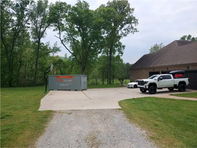 STORsquare portable storage container placed on a wide Clear Lake residential driveway near a pickup truck.