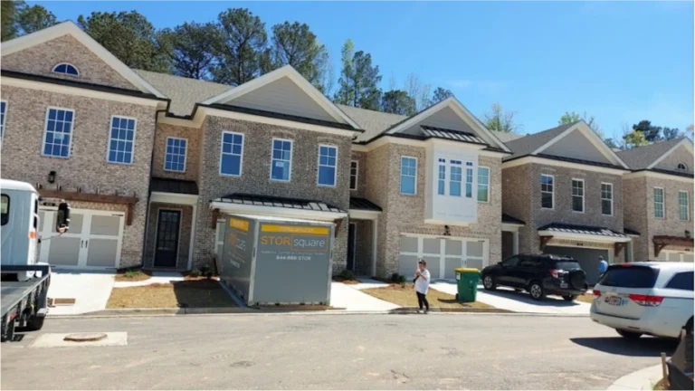 STORsquare storage container placed in a Friendswood townhome driveway with delivery truck nearby.