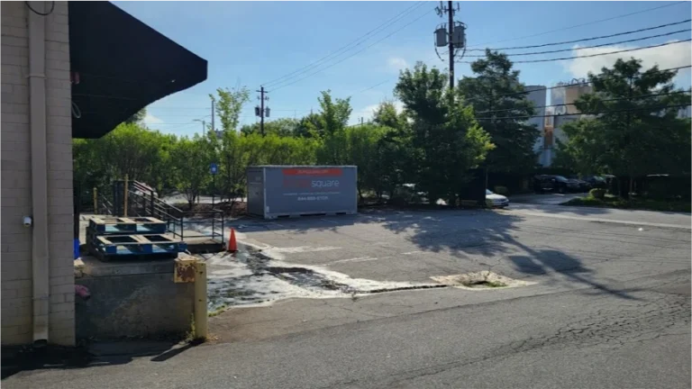 STORsquare storage container placed in a Fulshear commercial parking area near a building entrance and traffic cone.