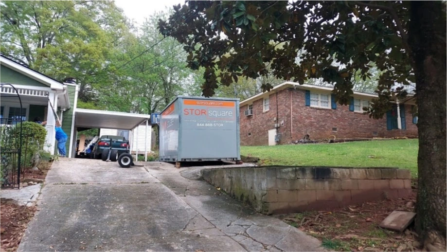 STORsquare storage container placed on a sloped Fulshear driveway beside a residential home and retaining wall.