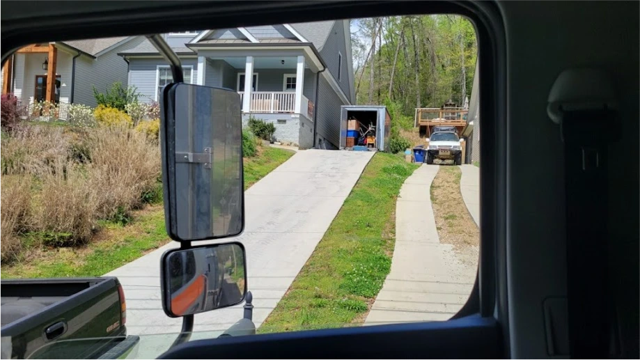 STORsquare portable storage container positioned at the top of a steep Fulshear residential driveway.