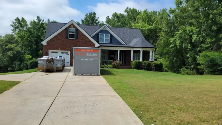 STORsquare storage container placed in a Galveston County driveway beside a home with renovation debris nearby.