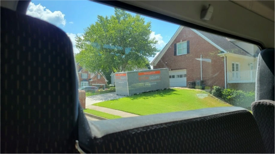 STORsquare storage container placed on a Harris County front lawn beside a brick residential home.