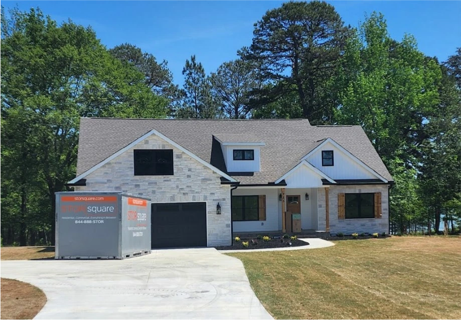 STORsquare storage container placed in a Montgomery County driveway beside a modern wooded residential home.