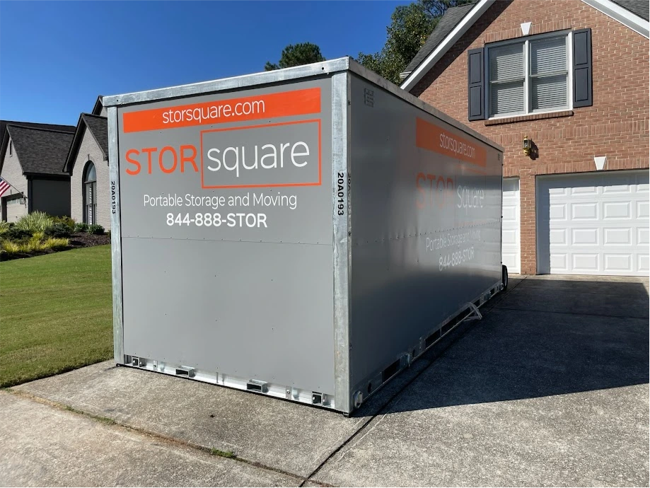 STORsquare portable storage container on a driveway beside a brick home in Sugar Land.