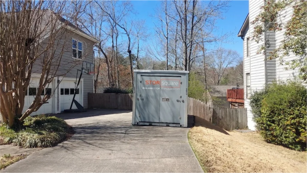 STORsquare storage container on a residential driveway between homes and trees in The Woodlands.