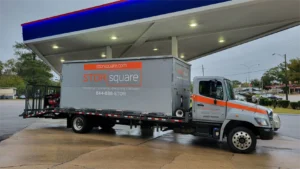 STORsquare truck delivering commercial storage containers to a business location.