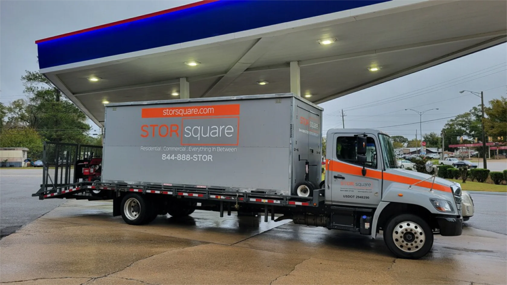 STORsquare truck delivering commercial storage containers to a business location.