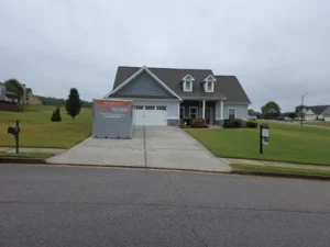 Driveway storage container rental placed in front of a residential home for moving or temporary storage