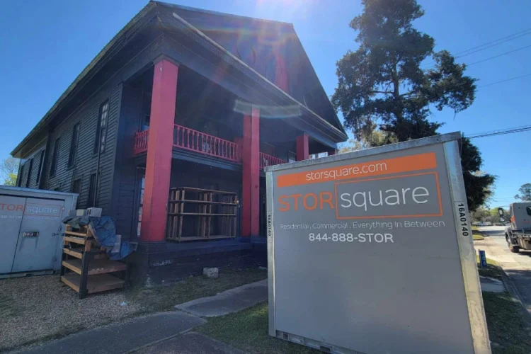 Mobile storage for moving containers placed outside a historic home during an interstate relocation.