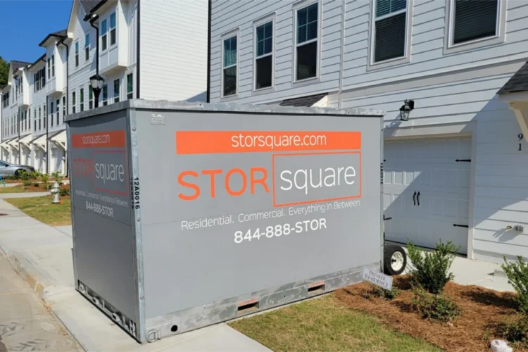 STORsquare portable storage container beside townhomes for couples following a newlywed moving guide