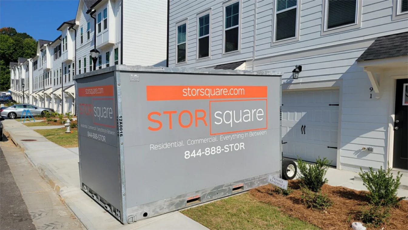 STORsquare portable storage container beside townhomes for couples following a newlywed moving guide