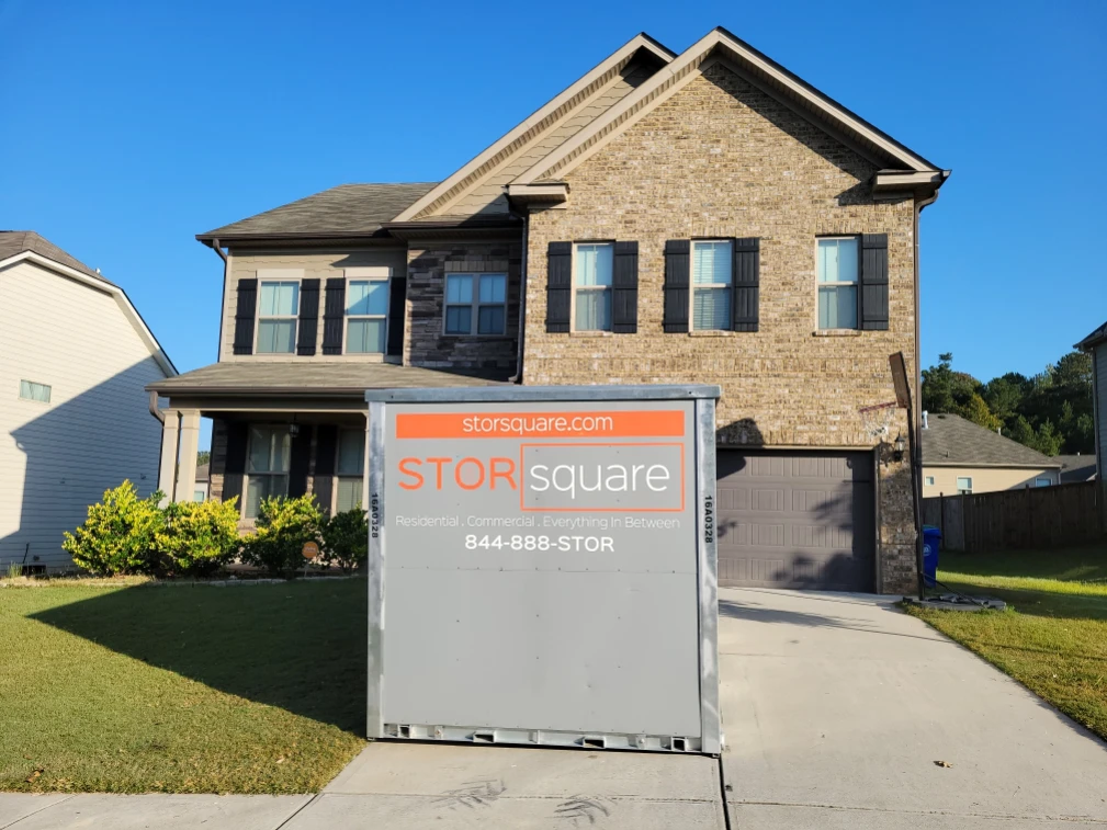 STORsquare storage container in a residential driveway during a newlywed home move