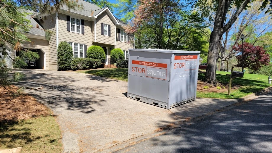 STORsquare portable storage container positioned on a residential driveway beside a two-story home in Fort Meade, FL.