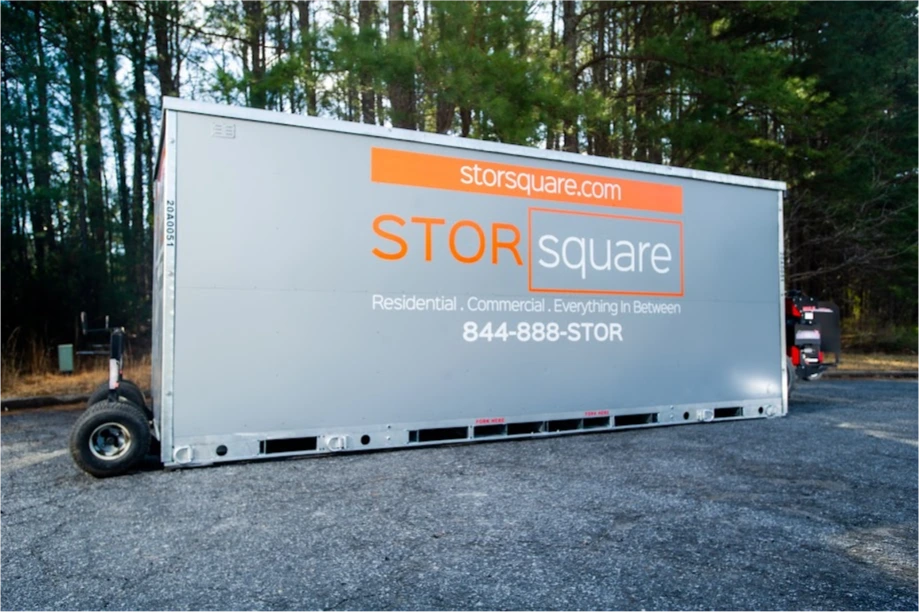 STORsquare portable storage container positioned on a gravel driveway beside a wooded area in Fairview, NC.