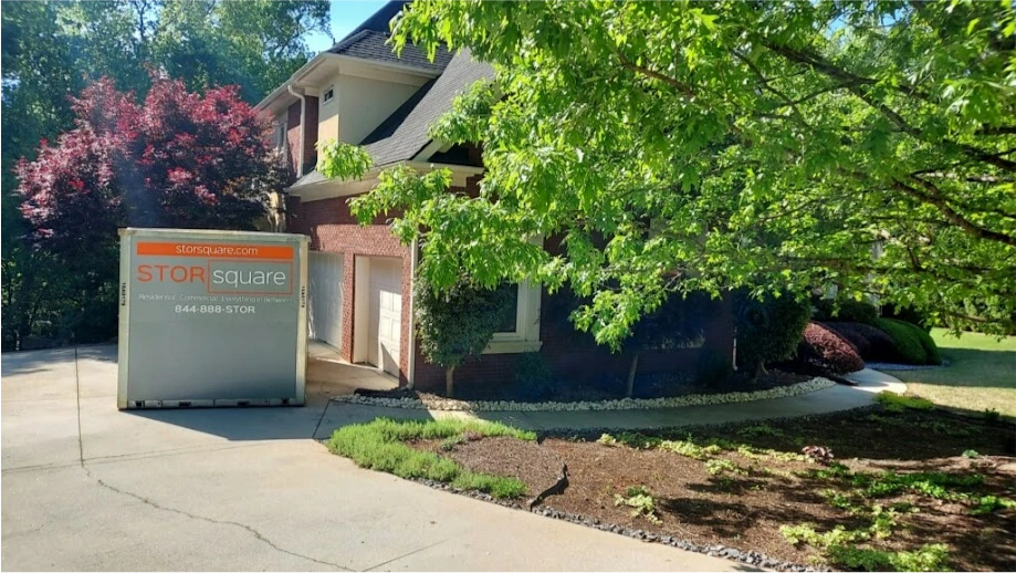 STORsquare mobile storage unit placed in the driveway of a brick home in Harriman.