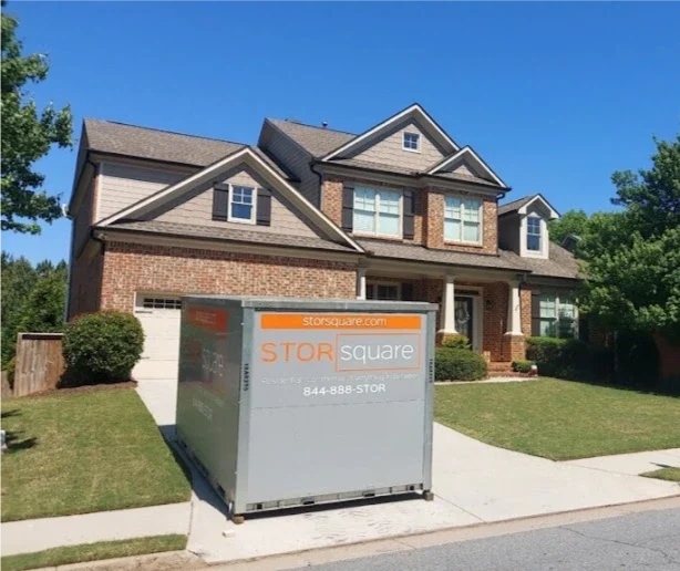 STORsquare mobile storage container in Landis placed in a residential driveway beside a brick home.