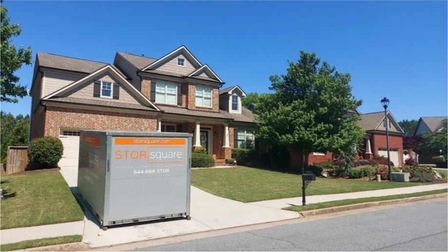 STORsquare mobile storage unit placed in a Weddington driveway in front of a brick home.