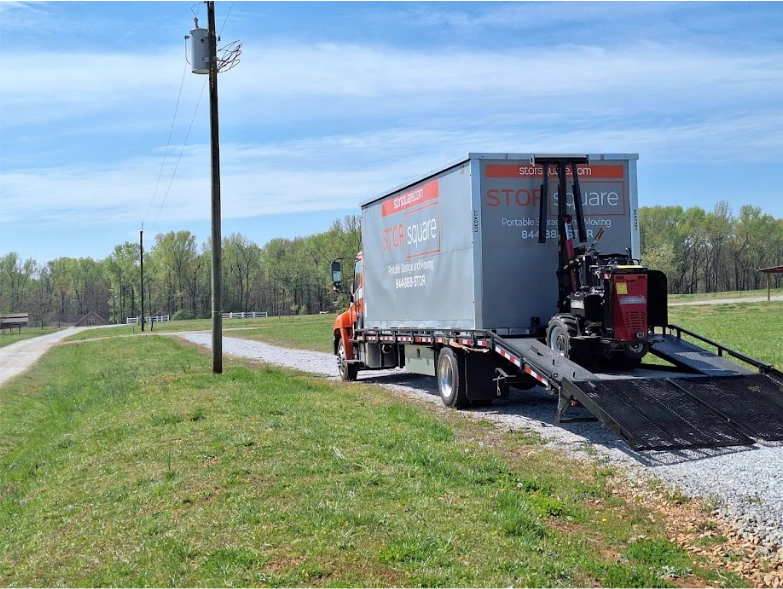 STORsquare portable storage container on a delivery truck along a gravel road in Mango.