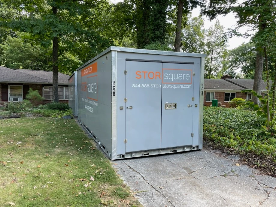 STORsquare portable storage container placed in a Weddington wooded driveway near a home.