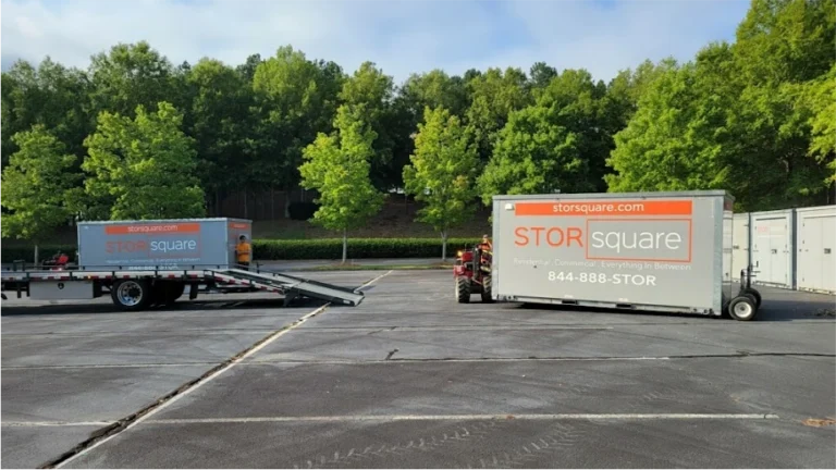 STORsquare portable storage containers in a Rockwood parking lot with delivery equipment and a truck ramp.