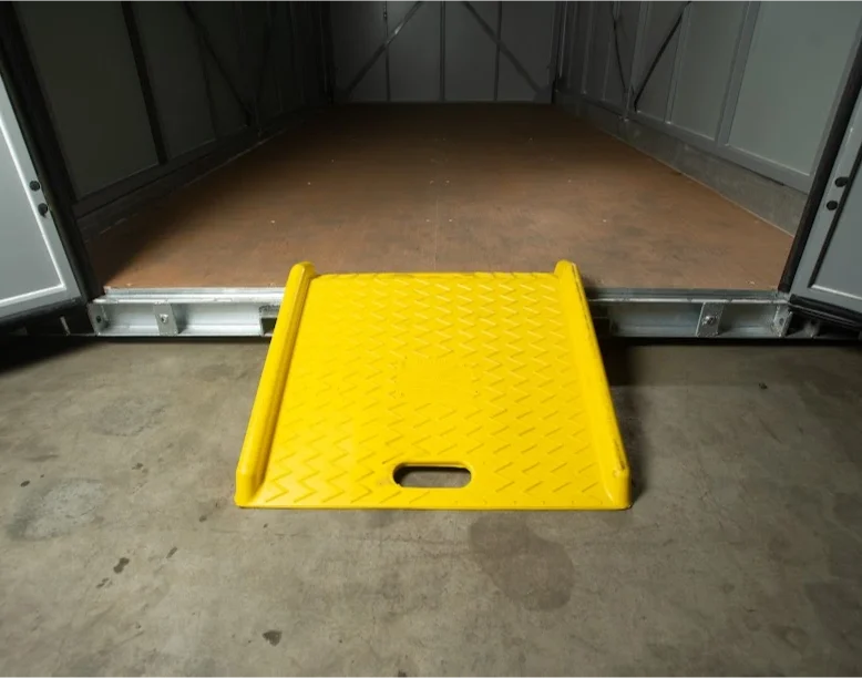 Yellow loading ramp placed at the open entrance of a STORsquare portable storage unit in Midland, NC.
