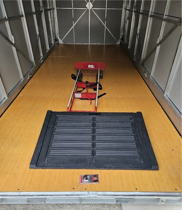 Inside a STORsquare portable storage container in Calhoun with a loading mat and moving dolly.